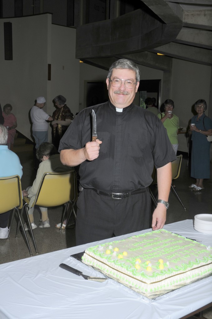 Pastor ready to cut the cake.